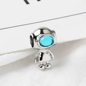 Macro view of silver astronaut charm with blue gemstone visor for DIY bracelets