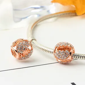 Rose gold hollow clover bead charm with crystals on silver snake chain bracelet