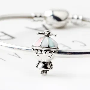 Sterling silver cartoon boy charm with colorful propeller hat on a heart clasp bracelet
