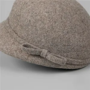 Elegant wool equestrian hat for women featuring a side bow detail in oatmeal grey felt