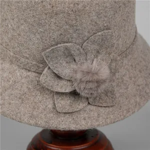 Elegant wool cloche hat for elderly women with handmade floral accents and fur pompom