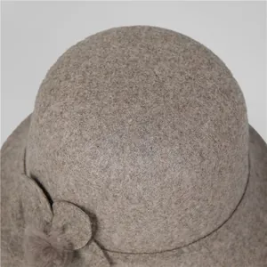 Woolen bucket hat for elderly women with decorative flower and plush ball in oatmeal color