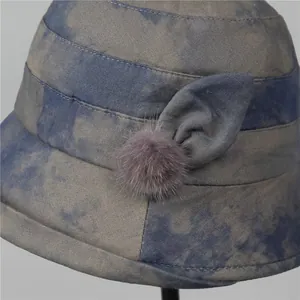 Elegant blue-grey tie-dye cloche hat for middle-aged women with pom-pom and bow detail