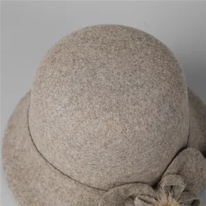 Elegant wool bucket hat for older women in light camel with floral and pompom detail