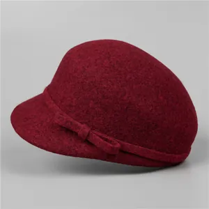 Detailed texture of burgundy wool felt cloche hat with an elegant ribbon bow design