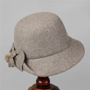 Detail view of oatmeal wool fedora hat with a side bow and plush pompom for women