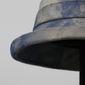 Close-up of the blue tie-dye texture and detailed stitching on a cotton bucket hat