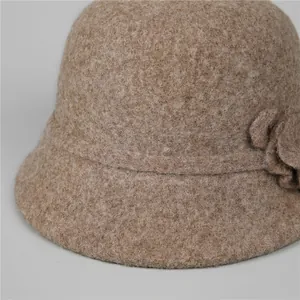 Detailed close-up of dark camel wool felt bucket hat with 3D floral accent for women