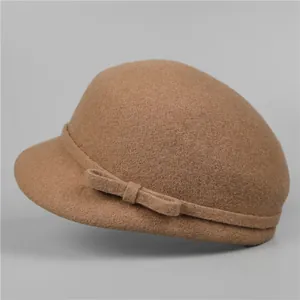 Detail of wool felt equestrian hat showing the camel fabric texture and a side bow knot
