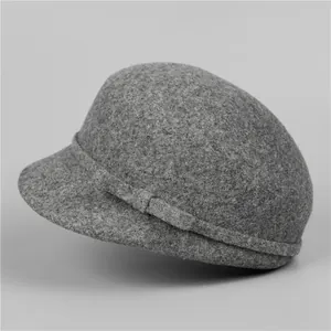 Close-up of dark grey wool felt equestrian hat showing texture and bow ribbon detail