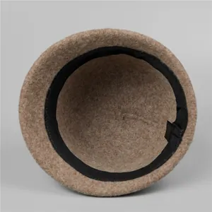 Inside view of camel wool cloche hat showing sweatband and soft fabric texture