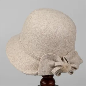 Detail of wool felt cloche hat for elderly women with decorative bow and fur pompom
