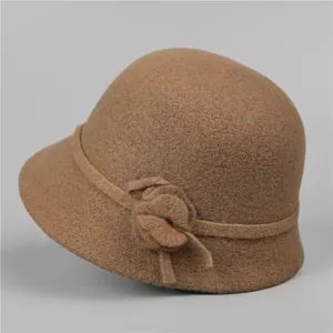 Close-up of elegant wool cloche hat featuring a detailed 3D flower accent in brown