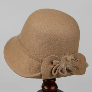 Close-up of wool cloche hat for elderly women with bow detail and soft fur ball