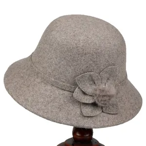 Elegant grey wool cloche hat for elderly women featuring decorative flower and pompom detail