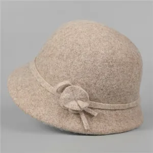 Detailed view of the wool felt cloche hat featuring an elegant decorative floral accent
