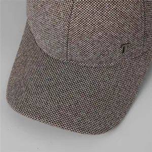 Dettaglio cappello da baseball invernale grigio testurizzato con logo in metallo e cuciture rinforzate