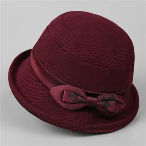 Detail of the elegant wine red wool bucket hat with decorative satin ribbon and bow