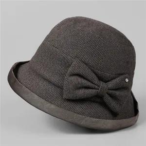 Detail of grey winter cloche hat fabric texture with bow and sparkling rhinestone