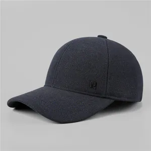 Detail of navy wool blend winter cap featuring a metallic letter N side ornament
