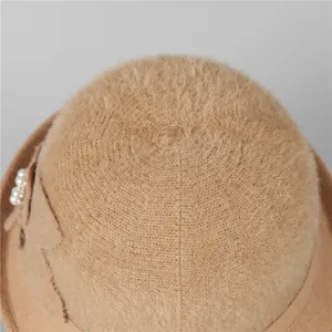 Elegant khaki fleece knit bucket hat for women with pearl bow detail and warm texture