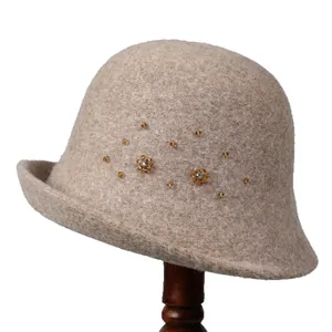 Eleganter beiger Wollhut für Damen mit Strasssteinen auf einem Vintage-Hutständer