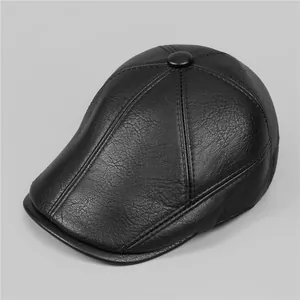 Detailed close-up of black PU leather flat cap showing lychee texture and stitching
