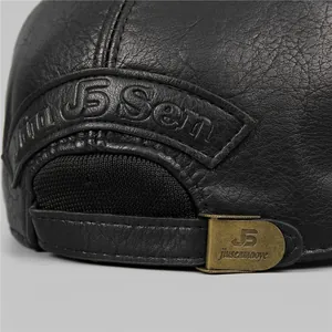 Detail view of premium black leather cap with adjustable metal buckle and stitching