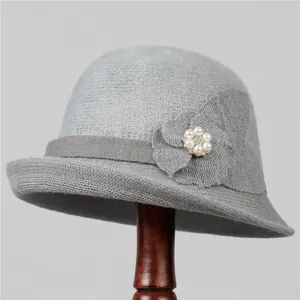 Detailed view of gray knit bucket hat featuring a floral accent with elegant pearl beads