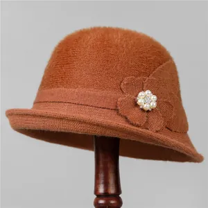 Detailed macro of vintage knit cloche hat featuring a 3D fabric flower with pearls