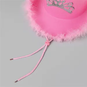 Close-up of pink cowboy hat with feather trim and a sparkling rhinestone tiara