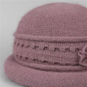 Close-up of pink winter knit hat showing fine fuzzy texture and floral detail