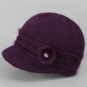 Detail view of purple knitted hat showing warm faux fur texture and rhinestone ornament
