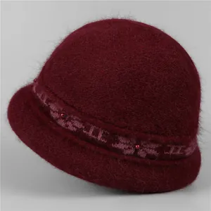Detailed texture of burgundy knit bucket hat with plush faux fur and floral jacquard trim