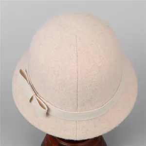 Elegant wool felt cloche hat for women in beige with a decorative ribbon bow