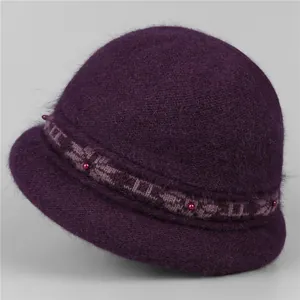 Detailed view of dark purple winter knit hat with floral jacquard and beaded accents