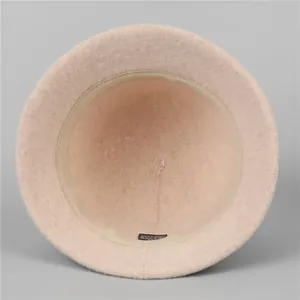 Elegant pink wool cloche hat for women showing interior lining and care label details