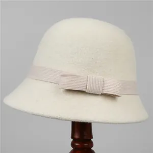 Detail of elegant cream wool felt cloche hat with a matching ribbon bow decoration