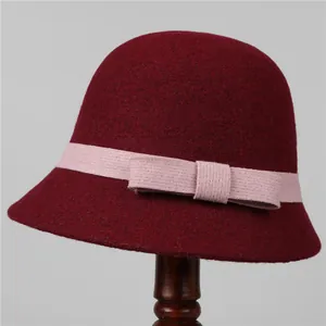 Detailed texture of a vintage wool felt cloche hat with pink ribbon and bow