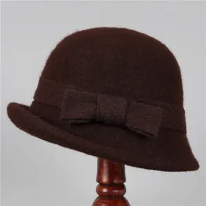 Close-up of brown wool felt cloche hat with elegant bow and rolled edge texture