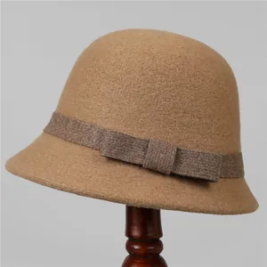 Close-up of elegant wool cloche hat texture with woven band and bow detail