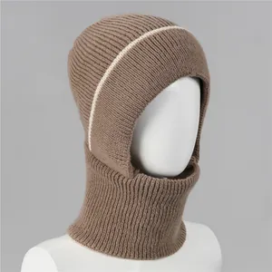 Detail of brown knitted winter balaclava with cream stripes and thick rib knit texture
