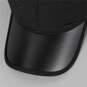 Detailed close-up of winter sports cap with leather brim and warm textured fabric