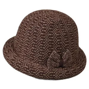 Women's warm knitted wool cloche hat in brown tones featuring a stylish side bow detail