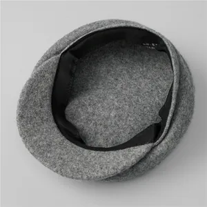 Detail shot of premium grey wool beret interior with lining and composition label