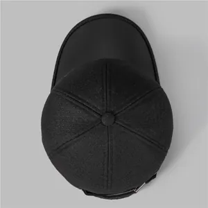 Men's winter baseball cap with ear flaps in thick black wool fabric, top view display