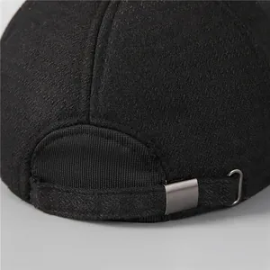 Close-up of black wool baseball cap for men with adjustable metal buckle at back