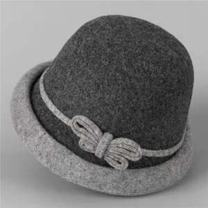 Détail d'un chapeau cloche en laine avec design bicolore gris et nœud tricoté élégant