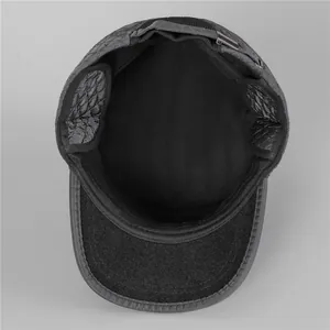 Detail of men's quilted flat cap featuring warm fleece lining and ear protection flaps