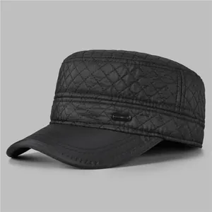 Detail of black quilted flat top cap with ear protection and warm padded lining